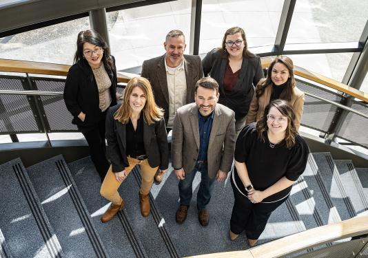 CELT staff standing on a staircase