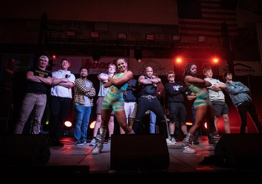 Flo Rida and dancers pose on stage with a group of Purdue University Fort Wayne students