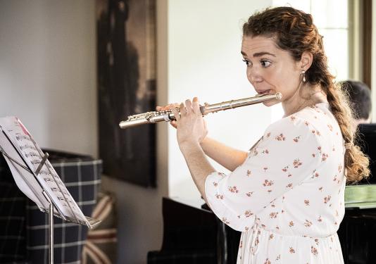 Katherine Marx is playing the flute