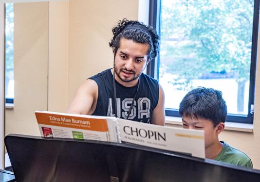 Christian Urizar is teaching a piano lesson