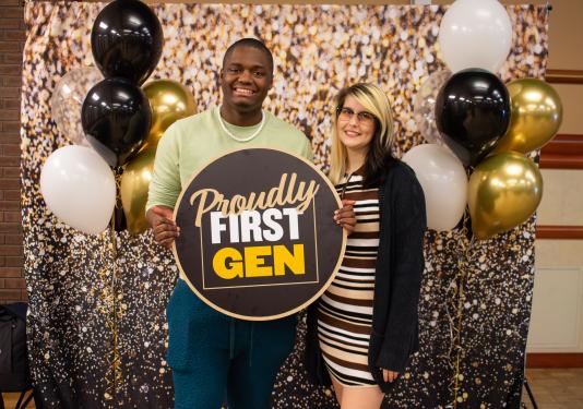 Students holding a First Gen sign.