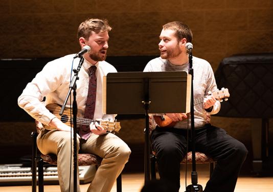 two men playing guitars