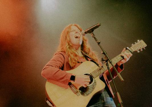 woman singing with guitar