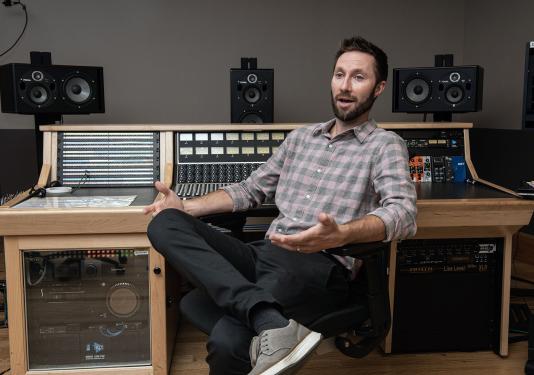 John Buteyn next to a sound board