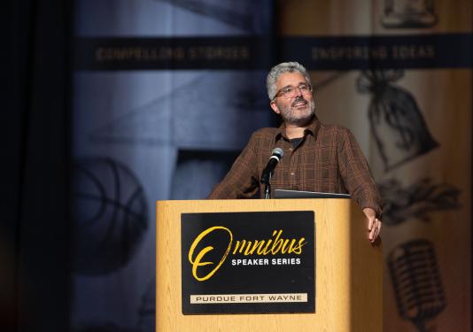 Michael Barbaro speaking behind a lecturn