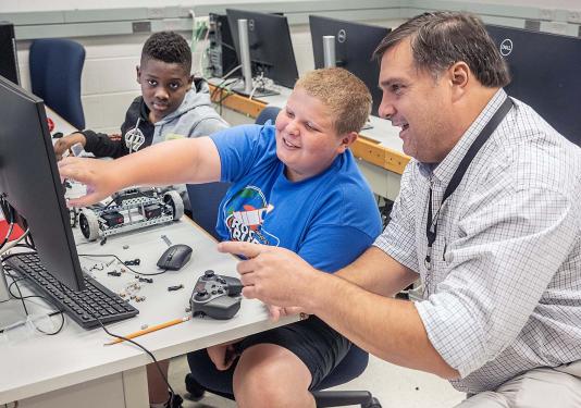 Jeff Nowak is working with students at a summer camp