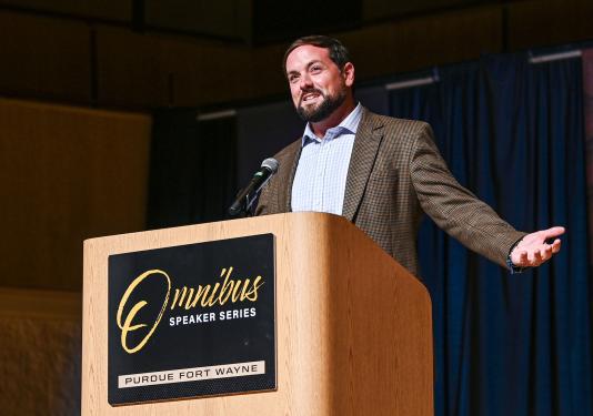 Luke Russert speaking at a lectern