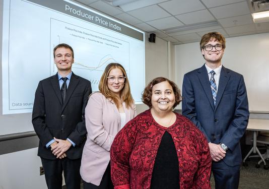 Carson Morton, Pia Briz, Heather Tierney, associate professor of economics, and Josh Fairchild. 