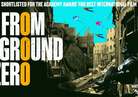 Poster showing the movie title "From Ground Zero" and text "Shortlisted for the Academy Award for Best International Film"; the background is a silhouetted person sitting among ruined, war-torn buildings.