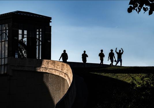 students crossing a pedestrian bridge