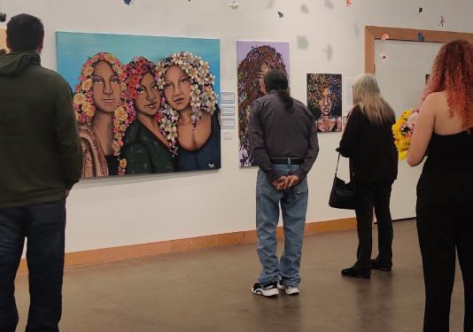 people looking at artwork