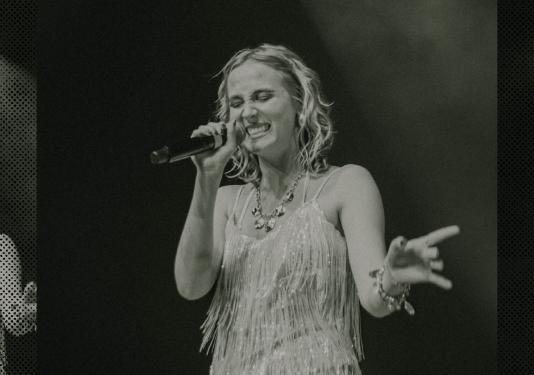 vocalist smiling and performing