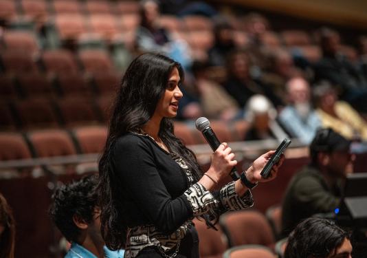 A student speaking into a microphone