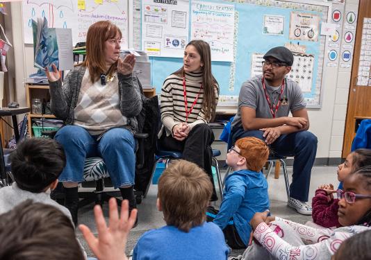 Student teachers observe during an elementary school lesson.