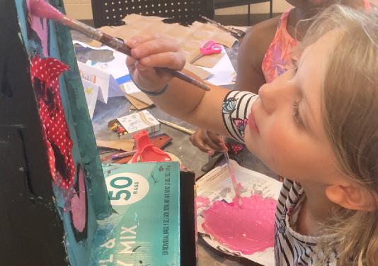 child painting on canvas creatively