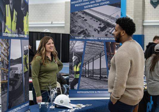 A student and employer at a career expo