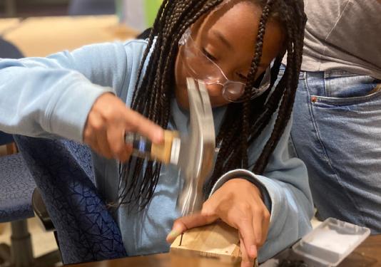 child making wooden creation