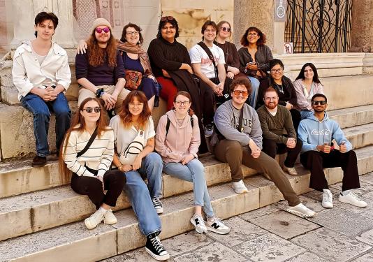 A group of PFW students sitting on stairsteps in Croatia