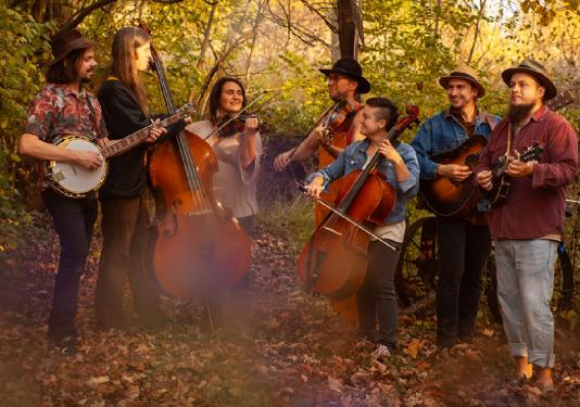 group of bluegrass musicians in a field