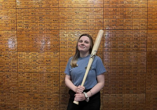 Hailey Bower holding a baseball bat