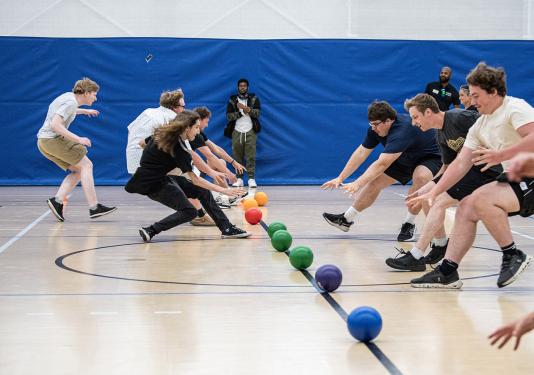 Students are lined up to start a game of dodgeball