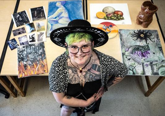 Dorian Soto surrounded by several of her works of art