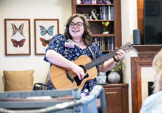 Brooke Sullivan is accompanying herself on the guitar while singing