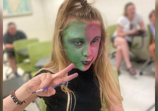 child doing face make up
