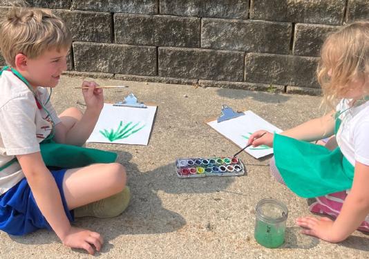 children painting outside