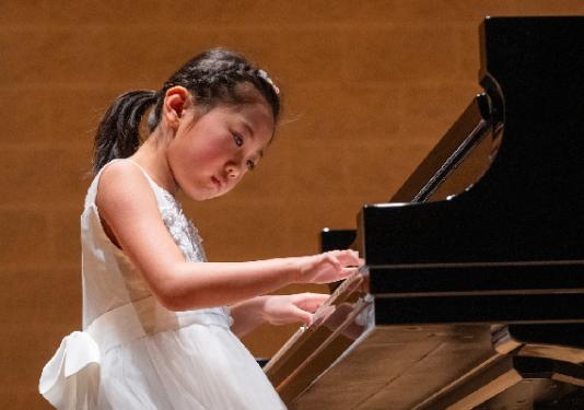 young girl playing piano 