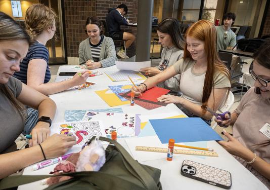 Students are crafting while sitting at a table