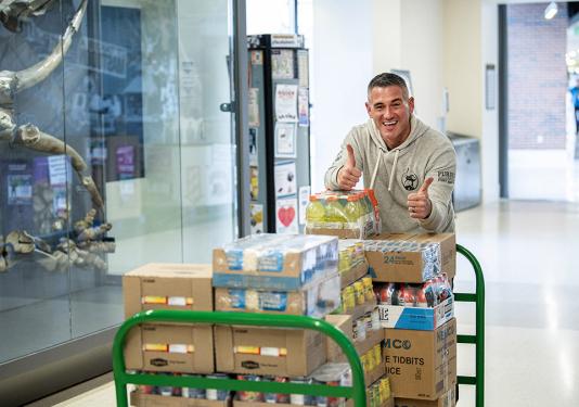 Eric Manor is moving items into a food pantry