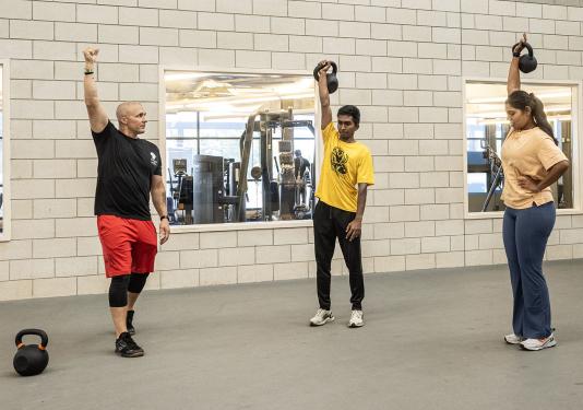 A police officer is leading a CrossFit class