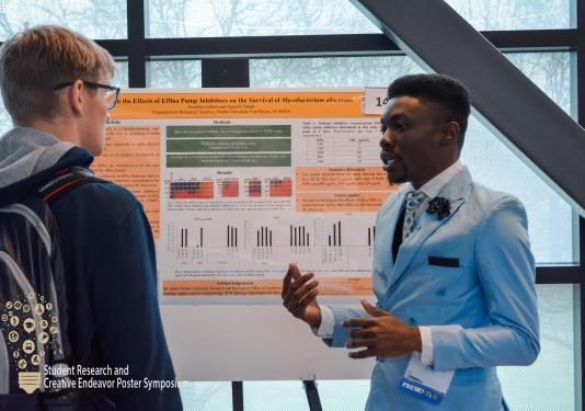 Student with research poster