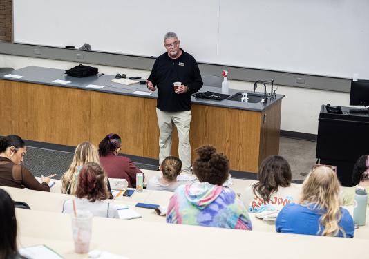 Carl Drummond is teaching a class in a lecture hall