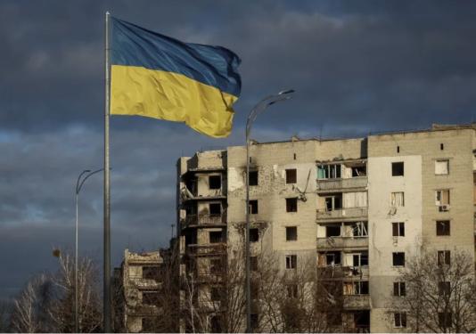 Ukraine flag flying in front of a building