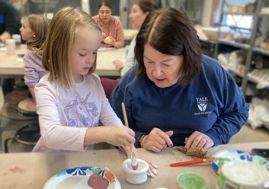 woman and child painting pottery