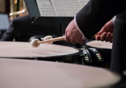 percussionist performing on timpani