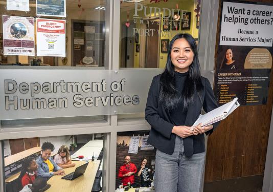 Mansan Kiim is standing outside of a department