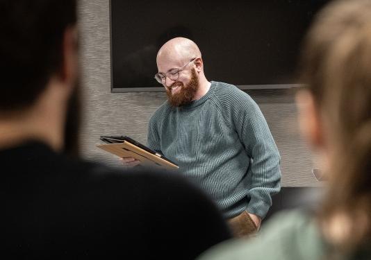 Eden Bailey is reading a poem in a classroom