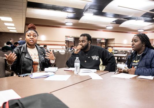 Students discussing at table