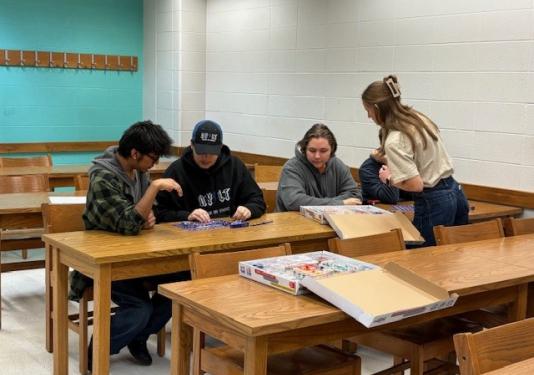 High school students doing a circuit connection activity with a student ambassador