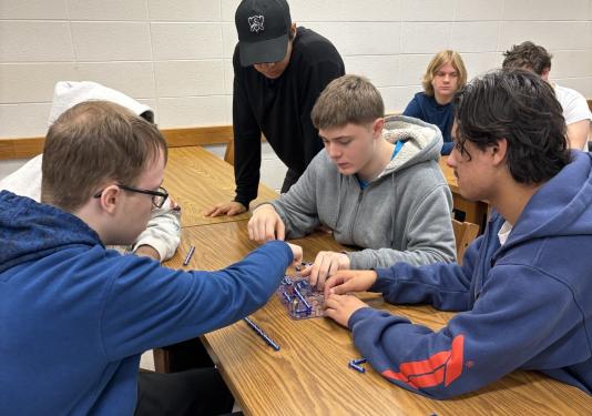 students working on circuit connection activity as a group