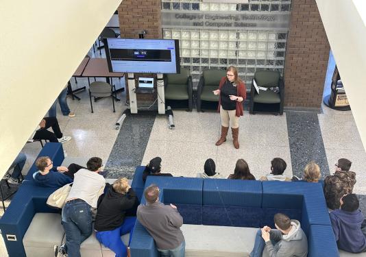 Director of ETCS giving opening statement to high school students before tours start in lobby