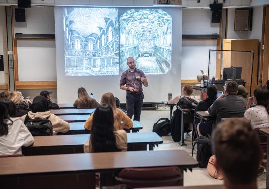 Professor providing instruction to a group of students.