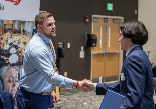 Prospective employer shaking student's hand