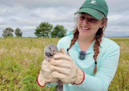 A student is holding a ground squirrel