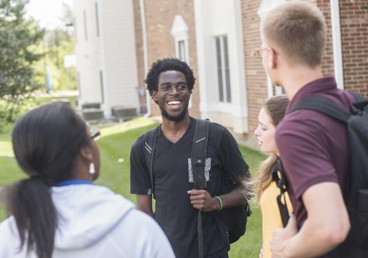 Students talking in a group.