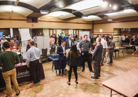 Students collecting information on careers at an accounting event on campus.