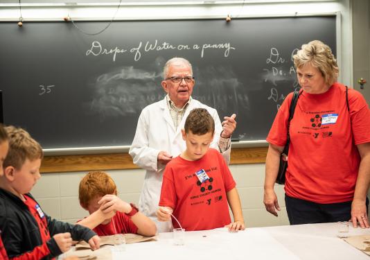 Photo of Professor Friedel working with students.